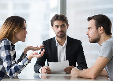 Mediator helping a couple discuss child custody issues.